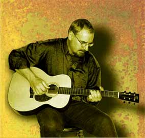 Picture of Todd playing a Santa Cruz acoustic guitar.